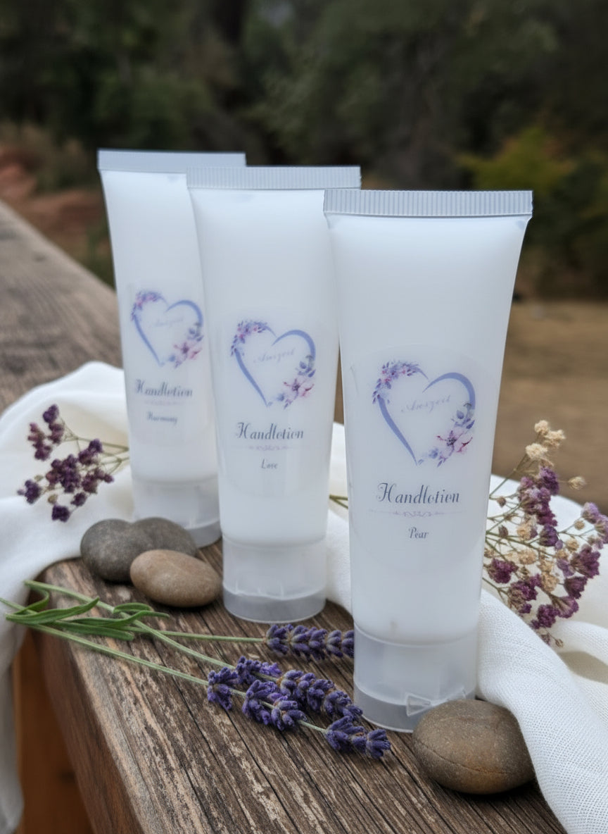 Multiple small tubes of hand cream on a wooden surface with a blurred natural background